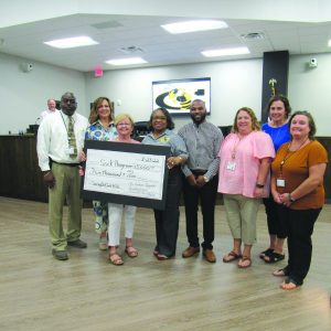 CCCVG members present a $5,000 donation in the Cook County Board of Education Meeting room