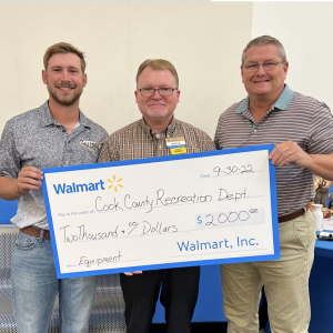 Adel-Cook Recreation Director Ross Pickle, Walmart Manager Marcus Johnston, and Cook County Commissioner Audie Rowe pictured
