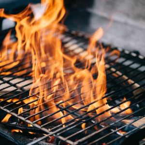 burning fireweood with flame through bbq grill