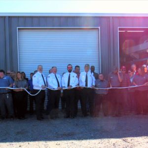 Attendees of the North Cook Fire Station dedication participate in a hose uncoupling ceremony