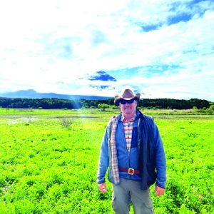 John Crosby stands with Mount Fuji in the background.