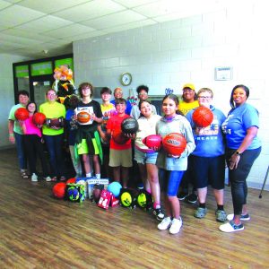 Members of the Boys and Girls Club and their donated balls and games